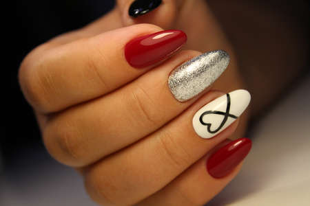 Closeup photo of a beautiful female hands with elegant manicureの写真素材