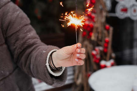 bright celebratory sparkler in woman handsの写真素材