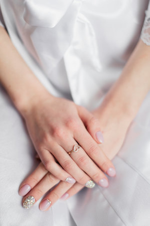 The morning of the bride. The wedding ring on the bride's hand.の写真素材
