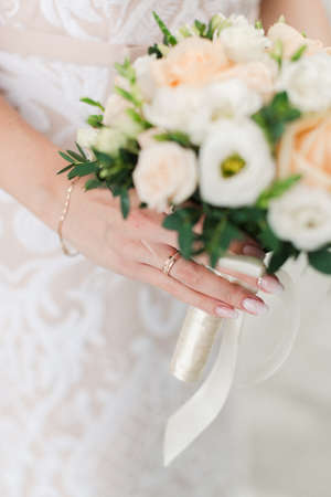 The bride is holding a wedding bouquet. Wedding bouquet in the hands of the bride.の写真素材
