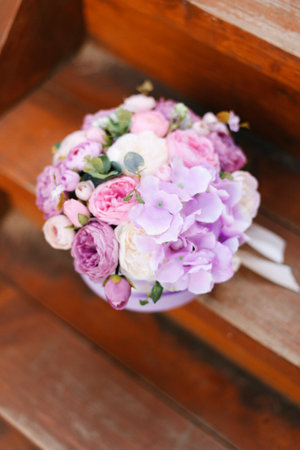 Purple, white, pink flowers in a round box. Flower composition. Decorative flowers.の写真素材