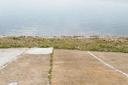 concrete slabs and grass on the background of the riverの写真素材