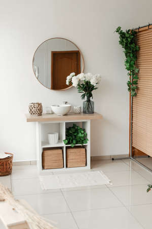 bathroom interior with mirror and flowersの写真素材