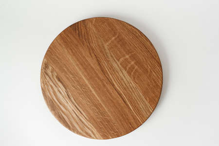 Round wooden tray on white background. Dishes made of natural materials. Wooden tableware. Wood texture.の写真素材