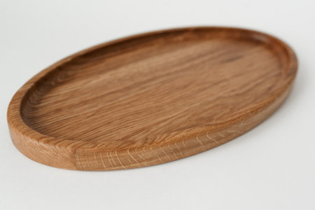 Wooden oval tray large on white background. Wooden utensils on white background.の写真素材