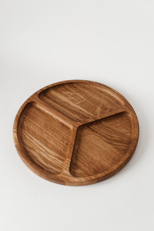 Compartmental dish on a white background. Dishes made of natural materials. Wooden bowl. Wooden tableware.の写真素材