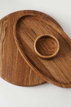 A stack of wooden plates on a white background. Three round ash wood pieces. Wooden utensils.の写真素材