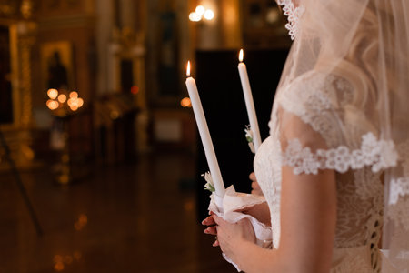 wedding ceremony. Church wedding. The bride is holding candles. White wedding dressの写真素材