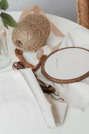 Items for embroidery on the table. Hoops, jute threads, linen cloth. Parts for hand embroidery.の写真素材