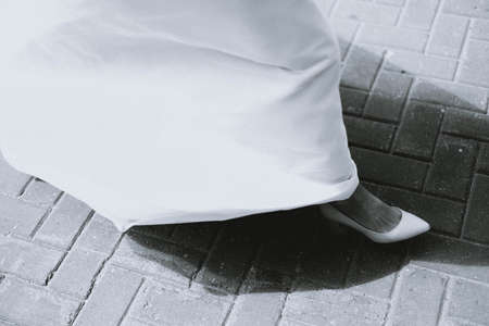 legs of the bride in a white dress and white shoes. Bridal clothingの写真素材