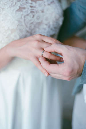 wedding ring on the finger. The groom puts the ring on the bride. wedding ceremonyの写真素材