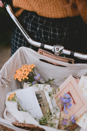 bicycle basket with decor. Flowers and postcards in a basket. Lifestyleの写真素材