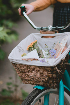 bicycle basket with decor. Flowers and postcards in a basket. Lifestyle