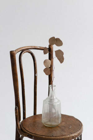 minimalistic vase on an old wooden chair. Retro design. Room interiorの写真素材