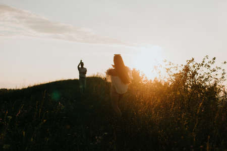 a man and a woman are walking in the sun, a date in the summerの写真素材