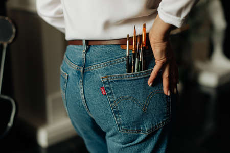 artist's brushes in the pocket of blue jeans art drawing