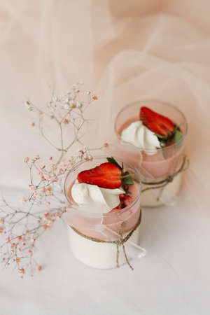 2 sweet strawberry dessert in a cup close-up on the tableの写真素材