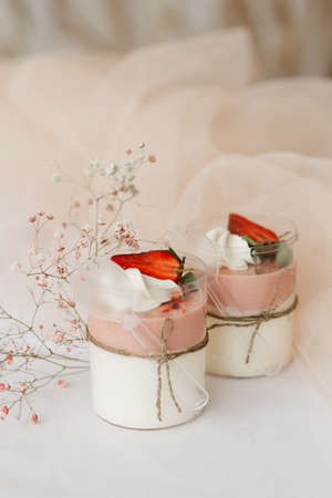 2 sweet strawberry dessert in a cup close-up on the tableの写真素材