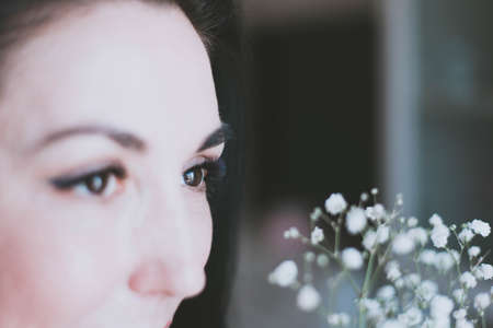 beautiful face of brunette girl and her eyelashes close upの写真素材
