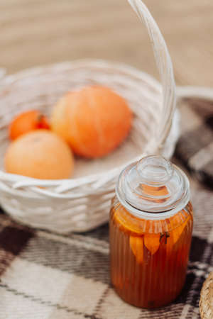 white wicker basket with pumpkins and jam autumn picnic close upの写真素材