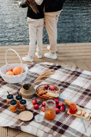 cozy autumn picnic close-up food and glasses with tea on a blanketの写真素材