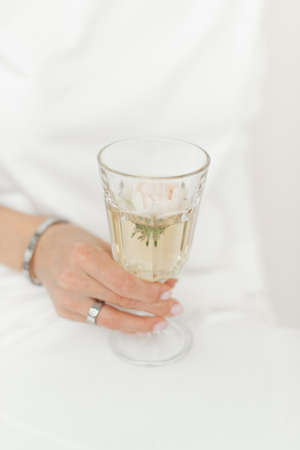faceted glass glass in the hands of a girl in white clothes