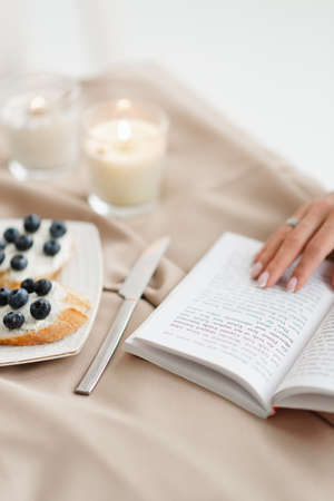 open book sandwiches and knife on the table close up minimalismの写真素材