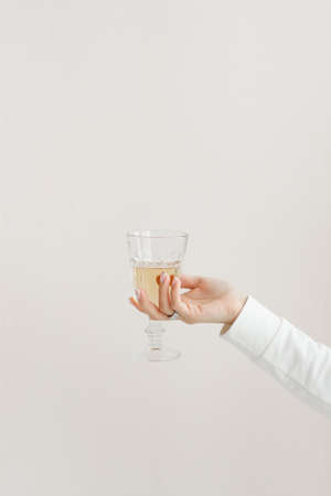 faceted glass glass in the hands of a girl in white clothes