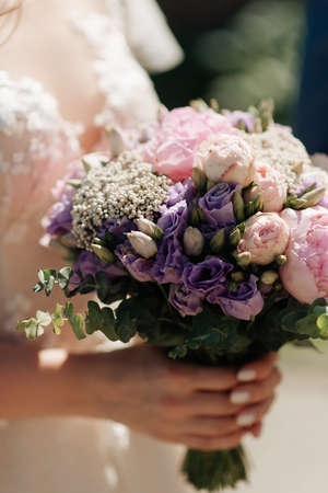 beautiful bridal bouquet in hands close-up morning brideの写真素材