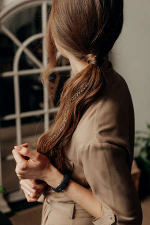 beautiful long dark hair in a ponytail young slim girl stands sideways
