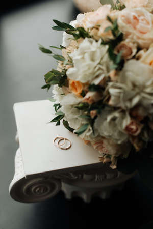 wedding rings and bridal bouquet close up top view morning brideの写真素材