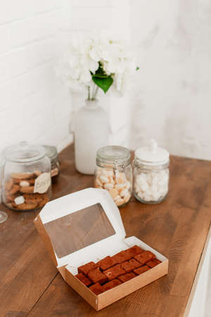 delicious bird milk in a cardboard box on a wooden tableの写真素材
