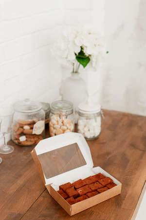 delicious bird milk in a cardboard box on a wooden table dessert for teaの写真素材
