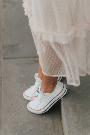 stylish bride in white sneakers unusual wedding lookの写真素材