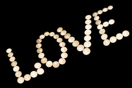 word "love" from candle on black backgroundの写真素材