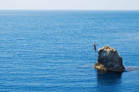 man jumping to the seaの写真素材