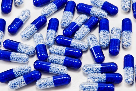 blue pills  isolated on whiteの写真素材