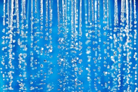 blue waterdrop falling background closeupの写真素材