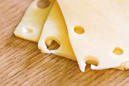 three piece cheese on wood tableの写真素材