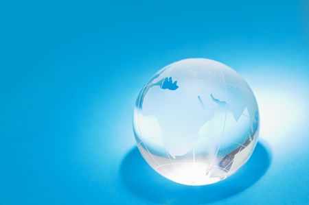glass globe on blue backgroundの写真素材
