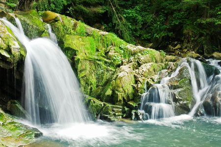waterfall on mountain in summer timeの写真素材