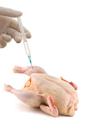 hand with syringe and chickenの写真素材
