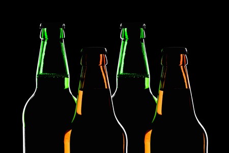 silhouette of brown and green beer bottle の写真素材