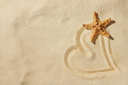 heart on sand on sea beachの写真素材