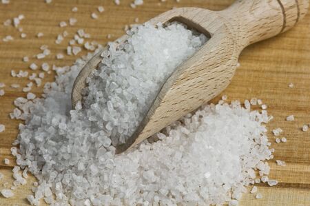 salt on wood spoon closeup