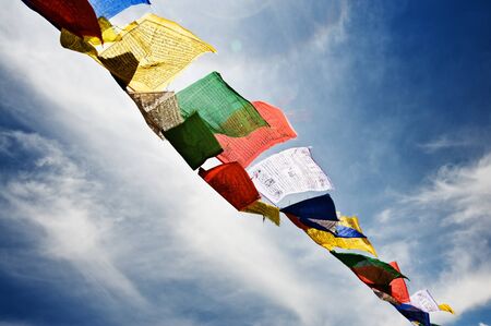 tibetan flags with mantra on sky background