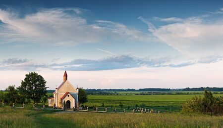catholic church on green meadowの写真素材