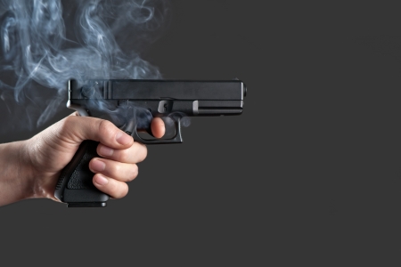 handgun in men hand closeupの写真素材