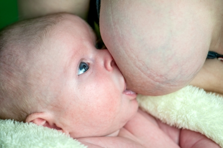 newborn boy eating close upの写真素材