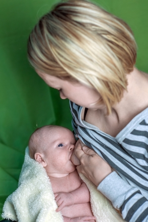 newborn boy eating close upの写真素材